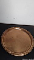 Top view of the 14-inch copper dish showing flat surface and beaded edge.