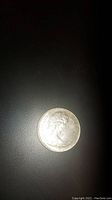 Obverse of 1967 Canadian silver dollar coin showing Queen Elizabeth II profile portrait.