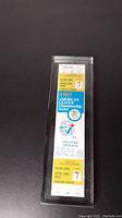 Front view of the 1985 ALCS Game 7 ticket showing game details, team logos, seating and date information inside a plexiglass case.