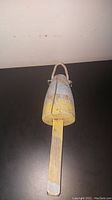 Top and side views of the wooden lobster bobber showing faded blue and yellow paint with a rope handle and wooden base stick