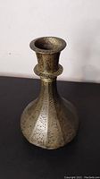 Side profile of brass smoker base showing shape and etched decorative patterns