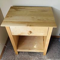 Front view of solid maple nightstand showing drawer and open shelf.