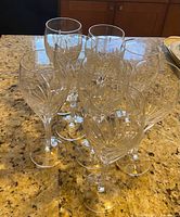 Eight Noritake Moondust crystal wine glasses on countertop