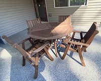 Table with four chairs arranged on covered patio