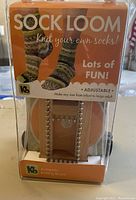 Front view of boxed K8 sock loom showing packaging with sock images and branding