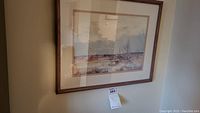 Overall view of the signed prairie scene wall art painting framed and hanging on the wall