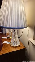 Photo capturing entire lamp with shade from a side angle, highlighting overall size and style.