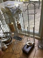 Wide view of the wire corner rack with items on and around it including a wooden tissue box holder and plastic bin.