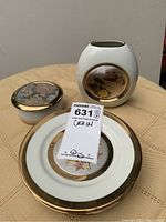 Photo showing four Chokin decorative plates and a white ceramic vase with bird and floral detailing.