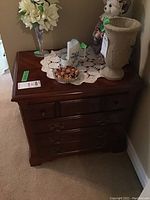 Front view of Kroehler wood night stand with decorative items on top and visible scratches on the wood surface.