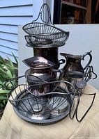 Photo showing all items stacked and grouped to display lot contents including bread baskets, ice bucket, pitcher, tray, coasters, and cups.