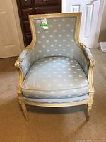 Front view of one chair showing wood frame and blue upholstery pattern