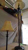 Full view of floor and table lamps with shades showing size and style differences.
