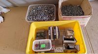 Overview of two bins: one with loose nails and assorted small boxes of nails and fasteners.