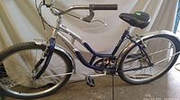 Front side view of girls' 26" Schwinn 5 Star cruiser bicycle showing blue and silver frame, black saddle, and chrome front fender.