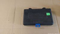 Closed black plastic carrying case for socket set with blue latch.