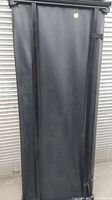 Folded black vinyl trifold tonneau cover showing its surface and construction details.
