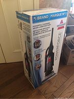 Front and side views of the Bissell PowerForce vacuum cleaner box showing branding, features, and model number.