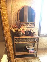 Console table and mirror displayed together in a room setting