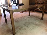 Full view of the dining table showing overall structure and condition