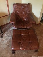 Front view of chair and ottoman showing overall design and condition