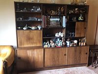 Straight-on view of the full wall unit showing open shelves, closed cabinets and overall finish.