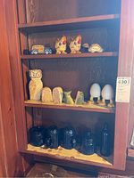 Full shelf showing assorted salt and pepper shakers and blue coffee canisters.