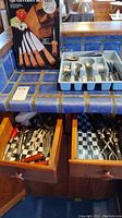 Open drawer showing additional kitchen tools, flatware and other cutlery items