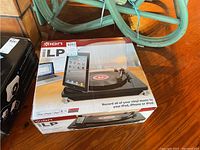 Photo of boxed Ion iLP turntable conversion system showing front of the packaging with product image and branding.
