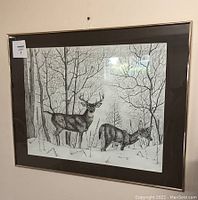 Frontal photo of the framed pencil drawing showing two deer in a winter forest scene, highlighting the gold-tone frame and brown matting.