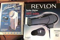 Revlon Turbo Styler 1875 watt hairdryer in original box beside boxed Clothes Shaver Plus fabric pill remover