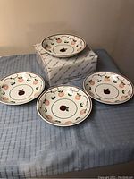 Four ceramic pasta bowls arranged with original Princess House box