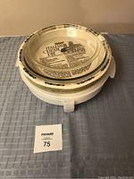 Stacked pie plates with travel stand on top, showing the Italian Cream Pie recipe plate.