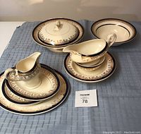 Full set of vintage Myotts Royalty China including soup urn, creamer, gray boat dish, two pasta bowls, two plates, and two serving trays on a blue cloth