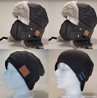 Four Bluetooth enabled toques shown on mannequin heads including two trapper hats with faux fur and two knit beanies, one with Bluetooth control buttons.