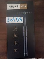 Front side of boxed Fairywill E11 electric toothbrush showing model name and features including smart timer, optional modes, fast sustained charge, and low power reminder.
