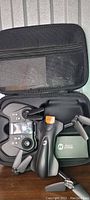 Holy Stone HS165 drone unfolded with remote controller inside a black carrying case with mesh compartment