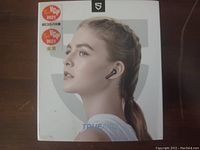 Front of box showing model and image of woman wearing earbuds