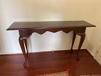 Full view of the wooden hall table showing tabletop, legs, and apron design