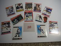 Full view of 11 Wayne Gretzky hockey cards laid out, showing various designs and poses with some highlighting season statistics and milestones.