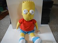 Front view of the Bart Simpson plush doll sitting upright against a white backdrop.