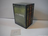 Closed outer box showing three DVD cases inside, labeled with The Lord of the Rings trilogy.