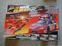 Original NASCAR 500 box showing branding, car imagery and track layout on front.