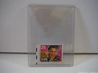 Elvis Presley 29 cent postage stamp in a clear protective holder.