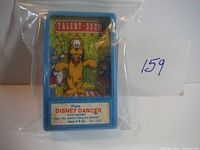 Front view of blue plastic toy with colorful Pluto label and instructions