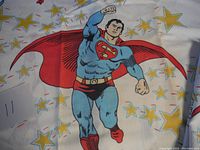 Close-up of vintage Superman figure on one pillow case with star patterns