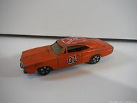 Front angle showing orange paint, roof decal, black wheels and side number 01.