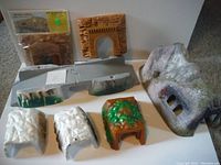 Overall lot showing various plastic and styrofoam tunnel portals and mountain landscape pieces for model train setups.