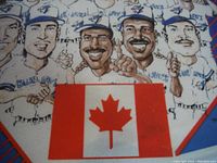 Close-up showing a red Canadian maple leaf on a white and red background, part of the pennant design.