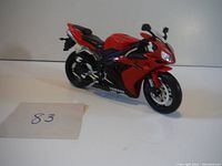 Side angled view of red Yamaha street bike replica showing detailed bodywork and paint.
